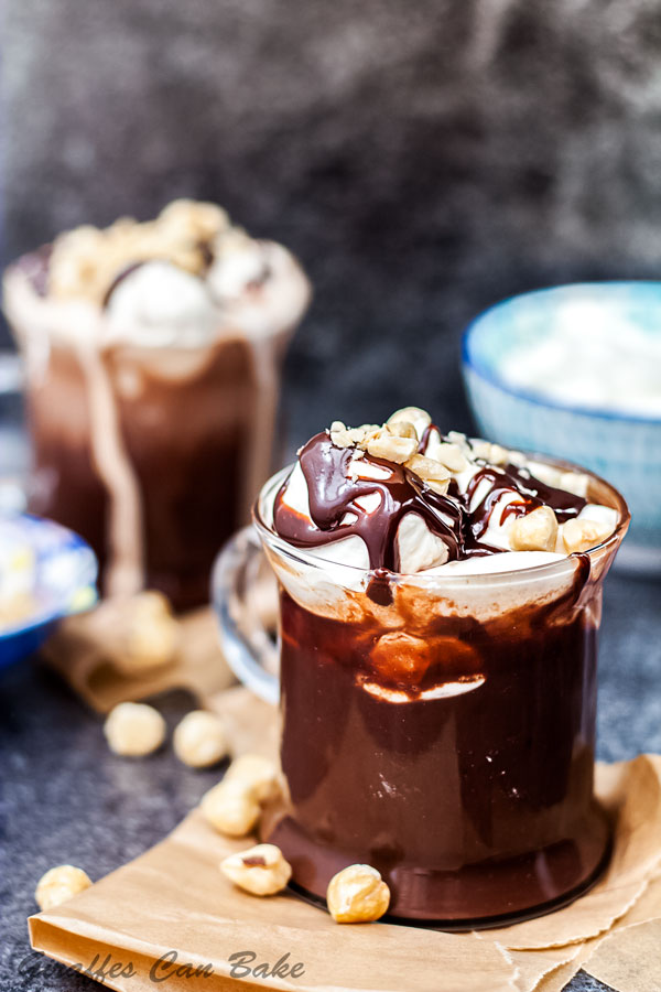 Hazelnut Italian Hot Chocolate - mug of hot chocolate with whipped cream and nutella sauce